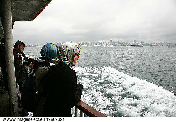 People in the a boat which is crossing the Bosphorus  Istanbul  Turkey.