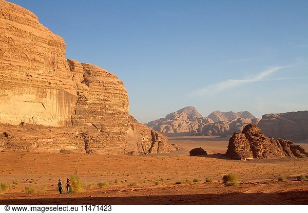 People in the Wadi Rum desert,  also known as The Valley of the Moon,  is a valley cut into the sandstone and graniterock in southern Jordan.