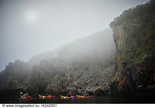 People kayaking in foggy weather