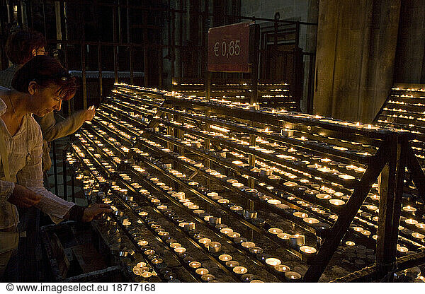 People lighting candles inside Saint Stephen's Cathedral  Vienna  Aust