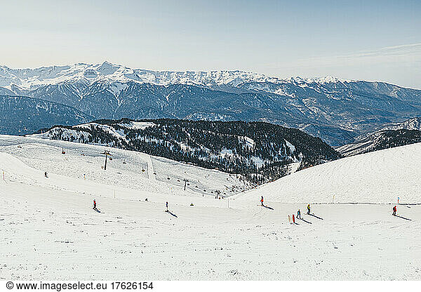 People on snowy mountain at ski resort