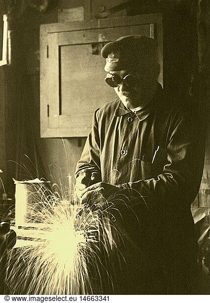 people  profession  metal worker  welder  Bamag Meguin AG  Berlin  Germany  circa 1928  1920s  20s  20th century  historic  historical  founded in 1872  machine construction  machine-building  labour  labor  labouring  laboring  work clothes  safety goggles  protective goggles  goggles  protective glasses  shower of sparks  workplace  place of work  working place  workplaces  places of work  working places  industrial worker  industrial workers  welder  welders  gas welder  Bamag Berlin-Anhaltische Maschinenbau AG  blue overall  man  men  worker  workers  half length  1930s  male