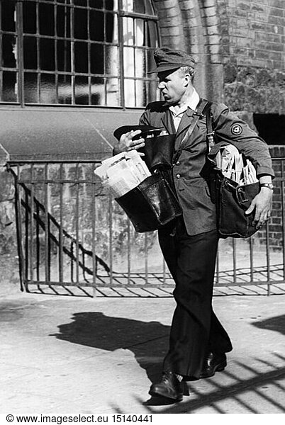 people  professions  postman  postman carrying many bags  1950s
