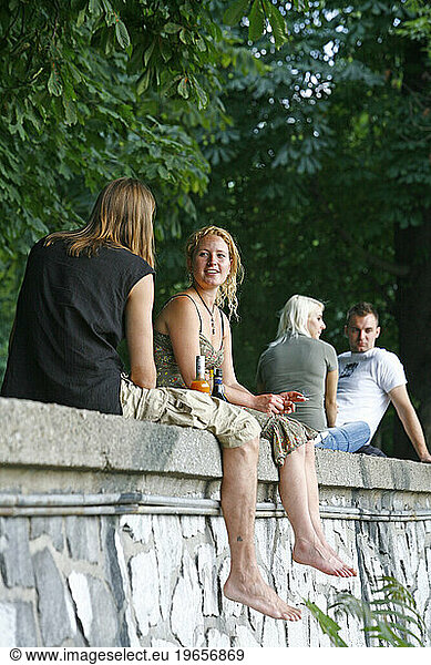 People sitting at a park in the Slovansky Ostrov (Slav Island)  Nove Mesto  Prague  Czech Republic.