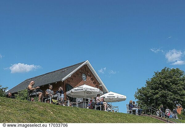 People sitting in the cafe at the flood embankment  Greetsiel  Lower Saxony  Germany  Europe.