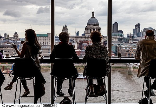 People Sitting In The Sixth Floor Restaurant At The Tate Modern Art Gallery With Views Of The River Thames and St Paul´s Cathedral  London  England.