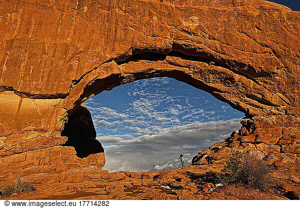 People Taking Photos Through The North Window Arch  Arches National Park  Utah