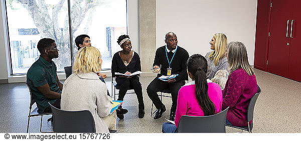 People talking in support group meeting circle in community center