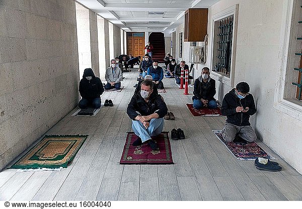 People wearing face masks perform Friday prayer  following the social distancing rule  in front of at the Kocatepe mosue in Ankara  Turkey  on May 29  2020. mosues across Turkey reopened on Friday after 74 days of closure as part of the normalization process amid a slowdown in the COVID-19 spread.