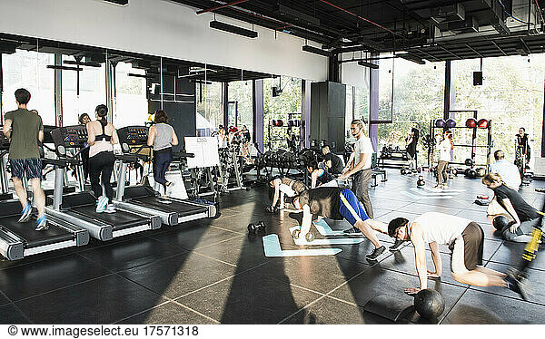 people working out during group fitness training at gym in Bangkok