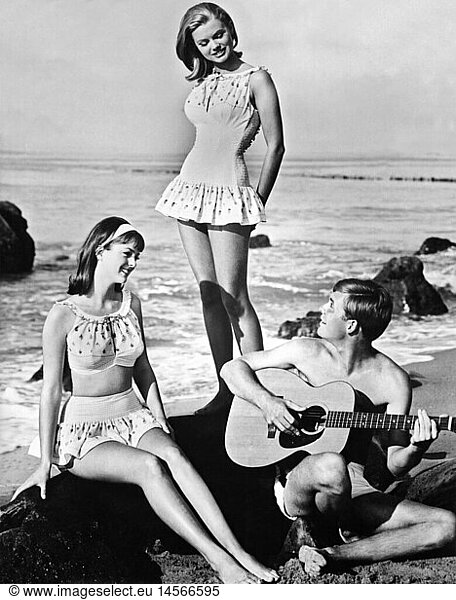 people  youth / teenager  group of teenagers on beach  1965