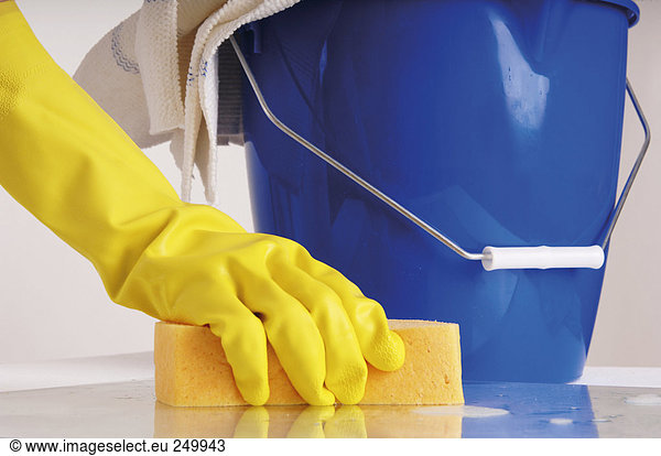 Person cleaning with sponge