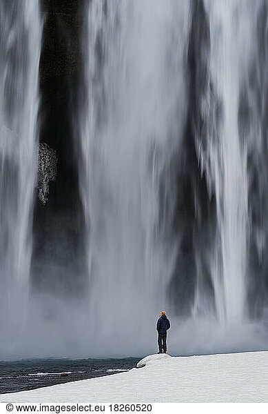 Person in front of Skógafoss Waterfall Iceland Photography