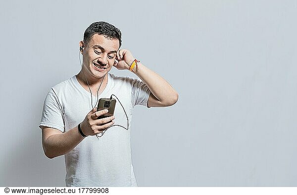 Person listening to music with his cell phone with headphones isolated  Handsome man enjoying music with headphones isolated  cheerful guy listening to music with his cell phone isolated