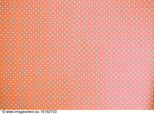 Pfirsich Aquarell Hintergrund Textur Pastell orange gefärbt mit weißen Polka Dots bunt.