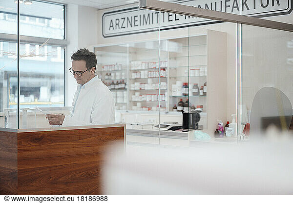 Pharmacist examining checklist at store