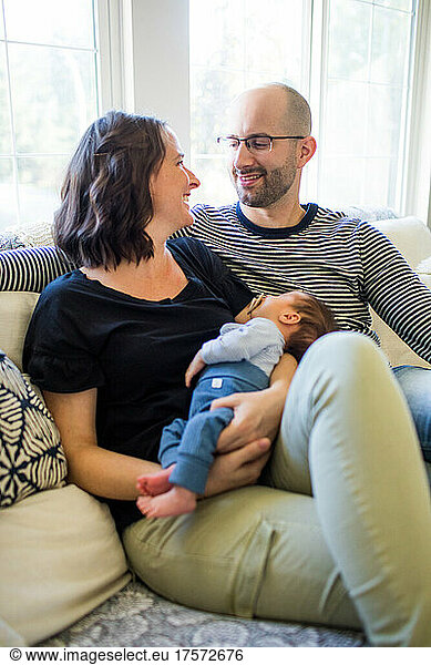 Photo of happy mother and father with their newborn baby boy.