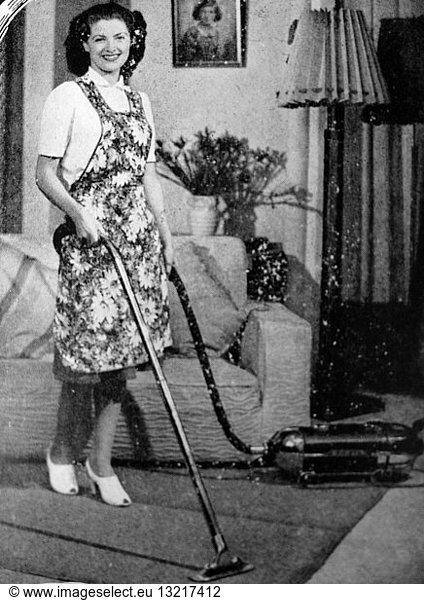 Photograph of a housewife using a hoover