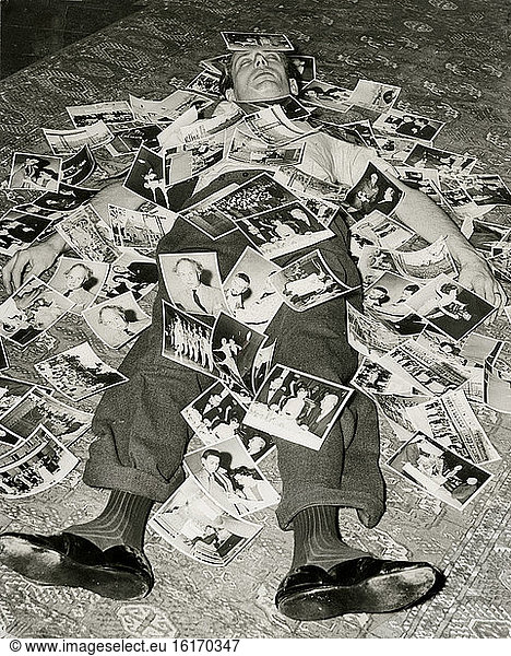 Photographer buried under prints  circa 1953