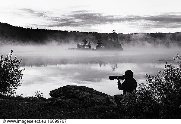Photographer captures morning fog at dawn on secluded Vermont Lake.