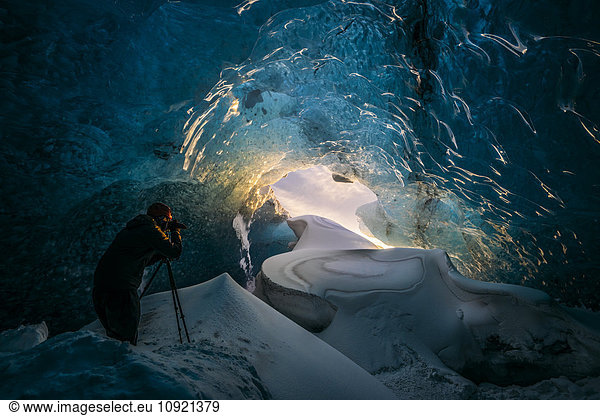 Photographer in ice cave  Iceland