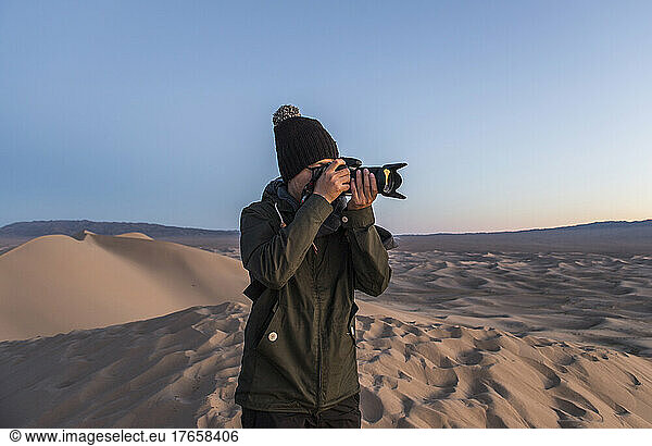 photographer shooting on the great sand dunes of the Gobi desert