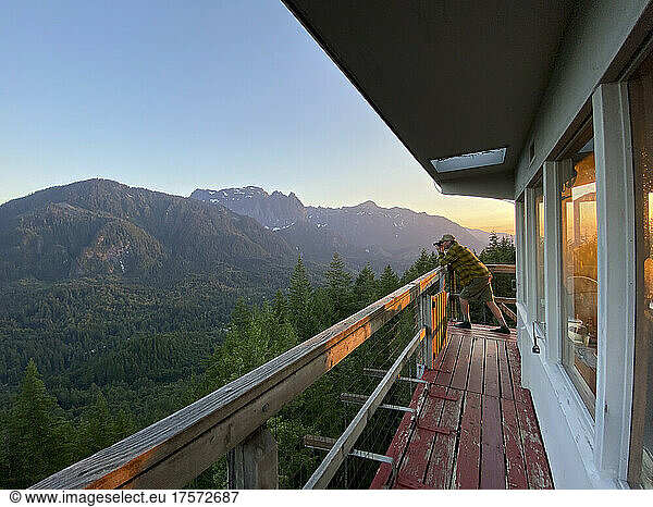 Photographer taking photo from the deck of a fire lookout tower