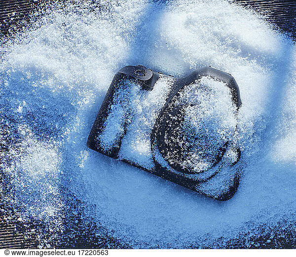 Photographic camera lying in snow