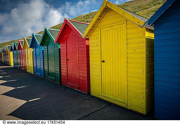 photography of beach changing rooms of different colors