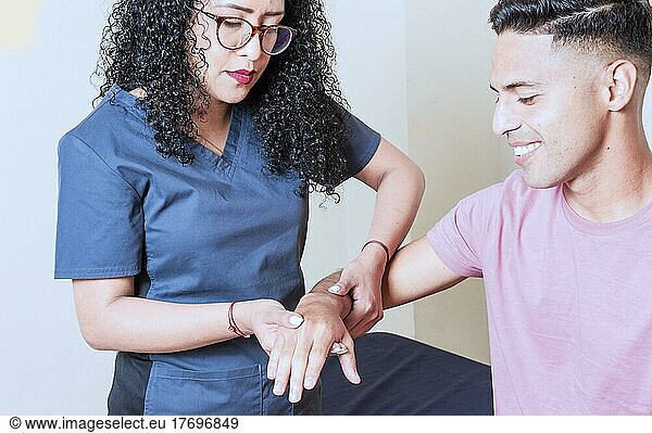 Physiotherapist with patient wrist assessment  wrist rehabilitation physiotherapy  hand wrist assessment