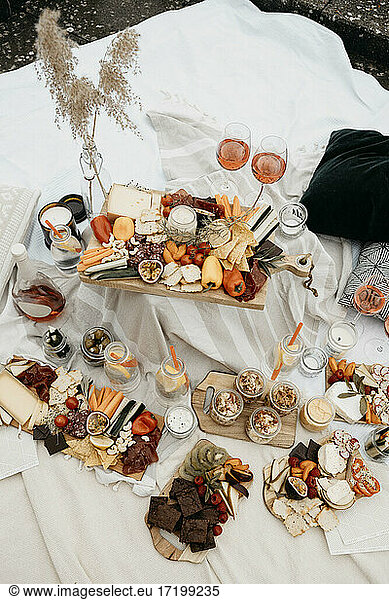 Picnic arrangement on white blanket at rooftop