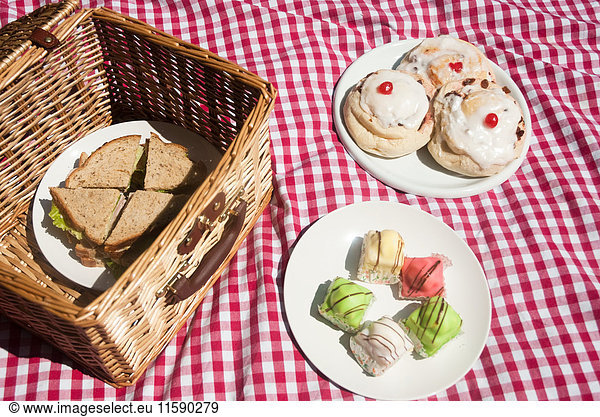 Picnic hamper with sandwiches and cakes
