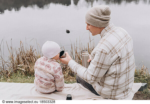 Picnic with dad in the park in early spring
