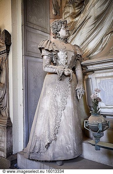 Picture and image of the stone sculpture in Borgeoise Realistic style of the Rossi family tomb. The monumental tombs of the Staglieno Monumental Cemetery  Genoa  Italy.