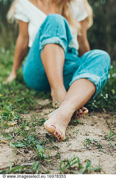 Picture Of Woman's Feet Sitting On The Grass