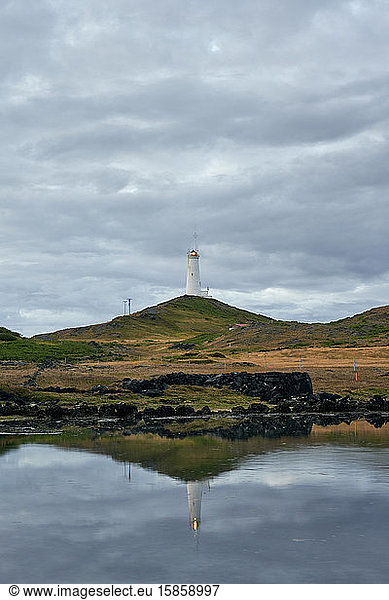 Picturesque scenery of lonely beacon under cloudy sky