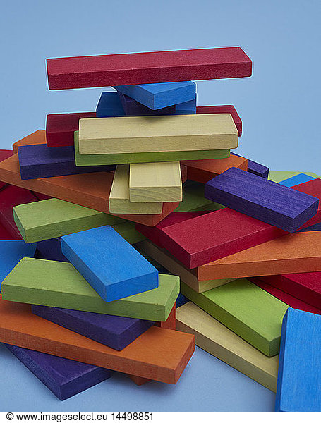 Pile of Colorful Wood Blocks on Blue Background