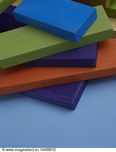 Pile of Colorful Wood Blocks on Blue Background  Close-Up