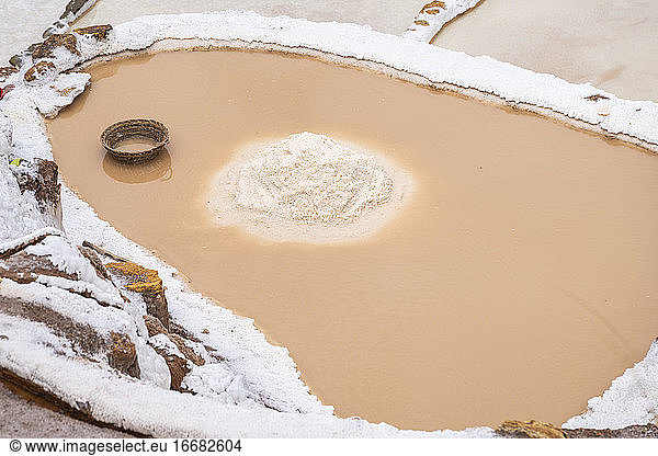 Pile of mined salt in middle of salt field  Salineras de Maras  Sacred Valley  Peru