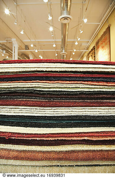 Pile of rugs  different colours  choice in a store.