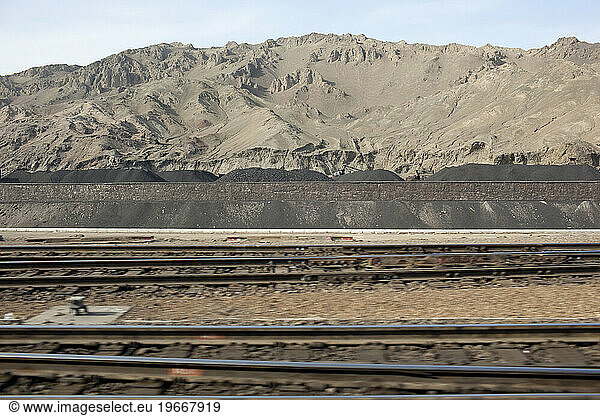 Piles of coal seen from a train south of Urumqi