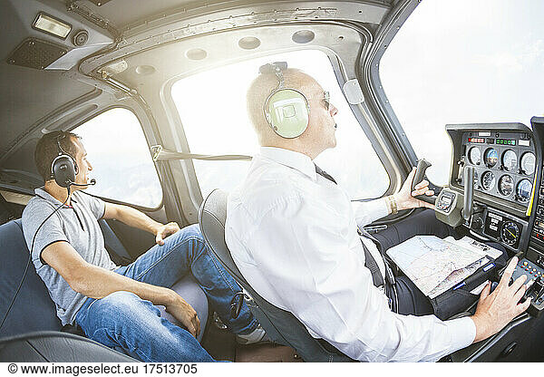 Pilot flying in sports plane  VFR chart on his lap