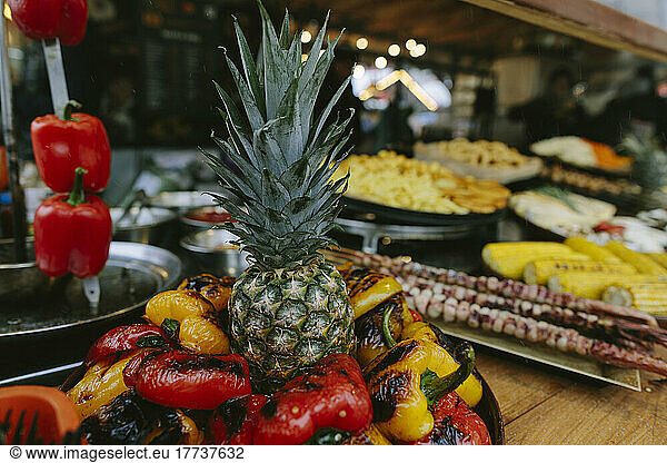 Pineapple amidst roasted bell peppers in restaurant