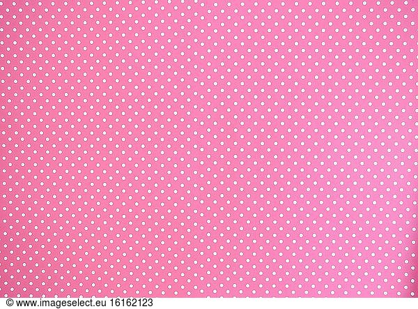 Pink background texture with white polka dots  Pink and white spot pattern can be used for background retro modern design beauty.