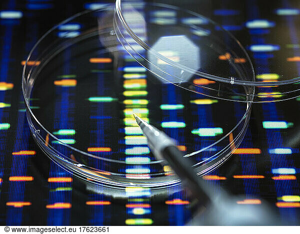 Pipetting sample into tray for DNA testing with profile in background