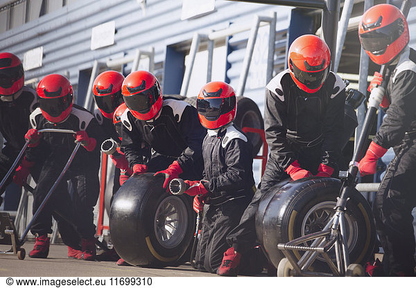 Pit crew ready with tires in formula one pit lane