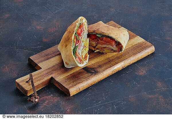 Pita bread stuffed with ham  tomato and omelette