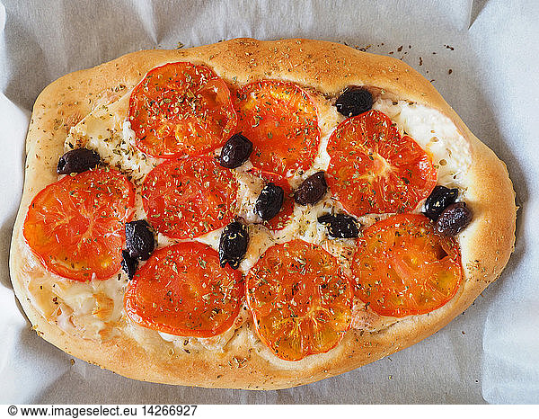 Pizza homemade with tomatoes  black olives  mozzarella cheese and oregano  Naples  Campania  taly  Europe