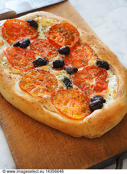 Pizza homemade with tomatoes  black olives  mozzarella cheese and oregano  Naples  Campania  taly  Europe