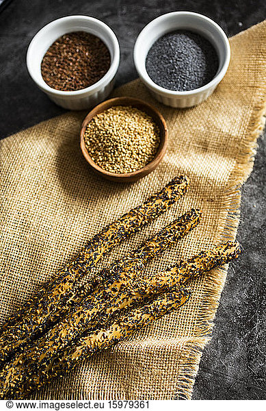 Place mat and fresh Italian grissini breadsticks with sesame  flax and poppy seeds
